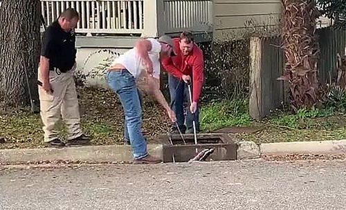 猫咪跑丢了,女子以为躲在门口的下水道里,找人撬开后却不敢动了