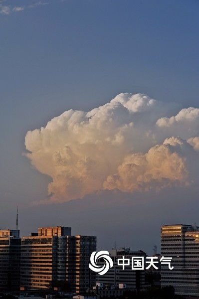 北京天空出现巨大积雨云 太阳西沉渐渐染橘